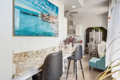 a kitchen and dining room with a large painting on the wall at Walkable Apt in York St Historic District in Newport