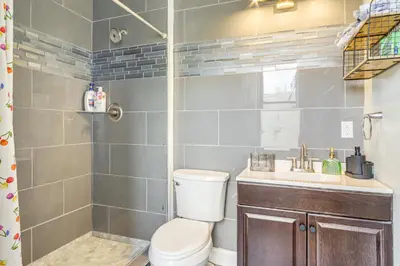 a bathroom with a toilet and a sink and a shower at Walkable Apt in York St Historic District in Newport