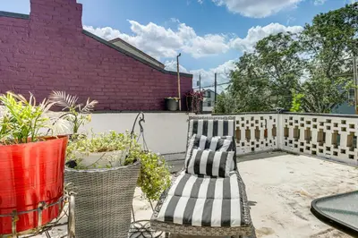 a patio with two chairs and a fence at Walkable Apt in York St Historic District in Newport