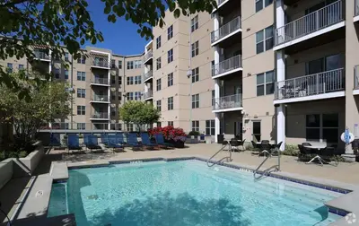 a swimming pool in the courtyard of a apartment building at CozySuites - Current at the Banks in Cincinnati