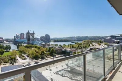 a view of a river and a bridge from a balcony at CozySuites - Current at the Banks in Cincinnati