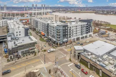 an aerial view of a city with a river and buildings at CozySuites - Current at the Banks in Cincinnati