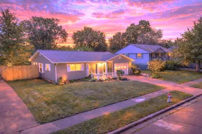 a house with a fire hydrant in the yard at Private Home - Entire House - Ranch - Hot Tub - Pets Welcome - 2 King Beds - Kids Welcome - Fenced Yard - Free Wifi - Quiet Neighborhood in Columbus