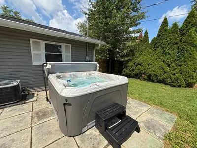 a hot tub in the backyard of a house at Private Home - Entire House - Ranch - Hot Tub - Pets Welcome - 2 King Beds - Kids Welcome - Fenced Yard - Free Wifi - Quiet Neighborhood in Columbus