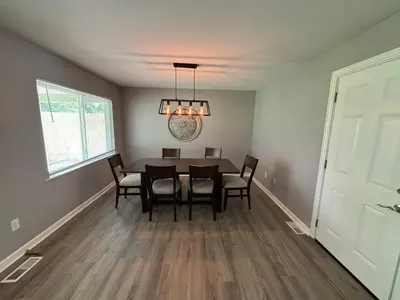 a dining room with a table and chairs at Private Home - Entire House - Ranch - Hot Tub - Pets Welcome - 2 King Beds - Kids Welcome - Fenced Yard - Free Wifi - Quiet Neighborhood in Columbus
