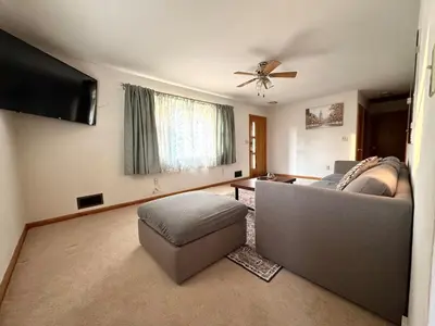 a living room with a couch and a flat screen tv at Bridgeport House WV, Close to UHC, FBI, The Bridge Complex in Bridgeport
