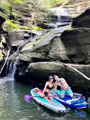 a man and a woman sitting on a raft in the water at Safari Tent Glamping in Kentucky with AC and Access to Biking Trails in Grayson