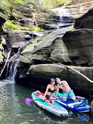 a man and a woman sitting on a raft in the water at Safari Tent Glamping in Kentucky with AC and Access to Biking Trails in Grayson