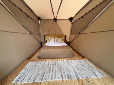 a room with a bed in a tent at Safari Tent Glamping in Kentucky with AC and Access to Biking Trails in Grayson
