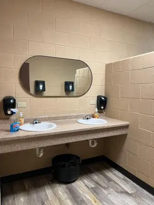 a bathroom with two sinks and a mirror at Safari Tent Glamping in Kentucky with AC and Access to Biking Trails in Grayson