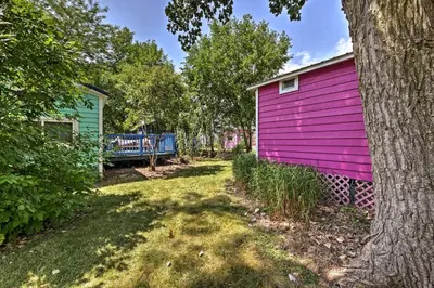 a pink house with a tree next to it at Resort Cabin 1 Mi to Middle Bass Island State Park in Middle Bass