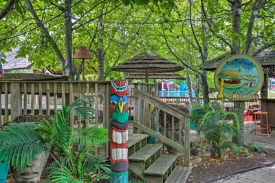 a totem pole in a park with stairs and a playground at Resort Cabin 1 Mi to Middle Bass Island State Park in Middle Bass