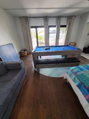 a living room with a pool table and a couch at Luxe Mt Adams Lookout in Cincinnati
