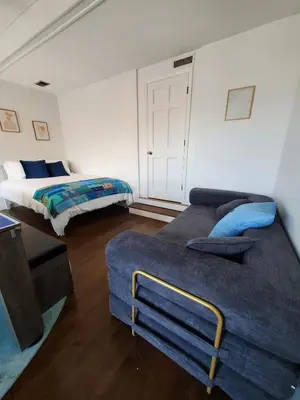 a room with two beds and a couch in it at Luxe Mt Adams Lookout in Cincinnati