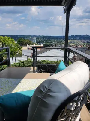 a balcony with a couch and a view of the city at Luxe Mt Adams Lookout in Cincinnati