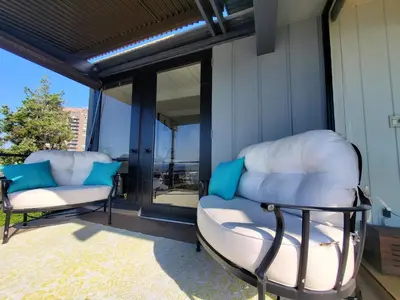 a pair of chairs sitting on the front porch of a house at Luxe Mt Adams Lookout in Cincinnati