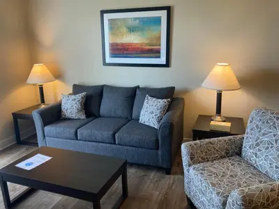a living room with a couch and a chair at Beautiful in Beachwood in Beachwood