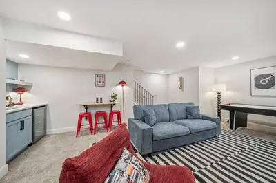 a living room with a couch and a table at Hot Tub - Mins to Short North - Retro Game Room in Columbus