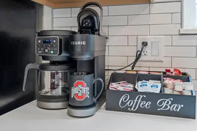 a coffee maker sitting on a counter next to a box at Hot Tub - Mins to Short North - Retro Game Room in Columbus