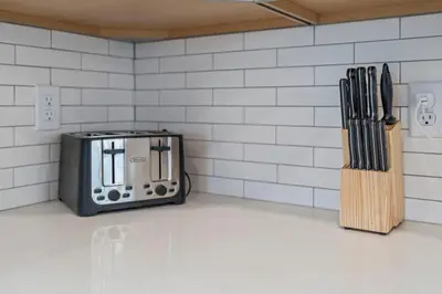 a kitchen with a toaster and knives on a counter at Hot Tub - Mins to Short North - Retro Game Room in Columbus