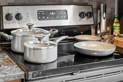 a stove with three pots and pans on it at Studio at Superior l Downtown l Parking l Café in Cleveland