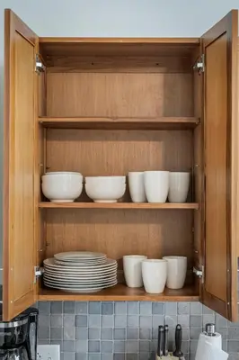 a cabinet filled with white bowls and plates at Studio at Superior l Downtown l Parking l Café in Cleveland