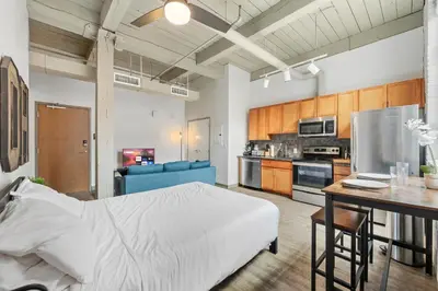 a large room with a bed and a kitchen at Studio at Superior l Downtown l Parking l Café in Cleveland