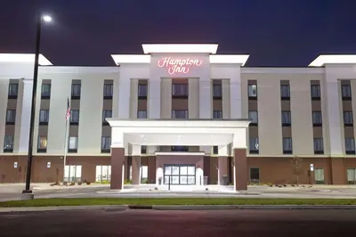 a large white building with a sign on it at Hampton Inn Toledo Oregon in Oregon