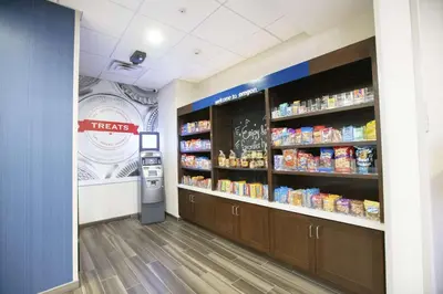 a grocery store aisle with a vending machine in a store at Hampton Inn Toledo Oregon in Oregon
