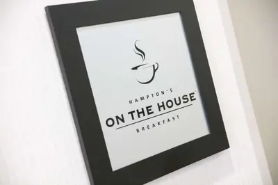 a black picture frame with a signature on the house at Hampton Inn Toledo Oregon in Oregon