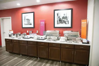 a counter in a store with a bunch of dishes at Hampton Inn Toledo Oregon in Oregon