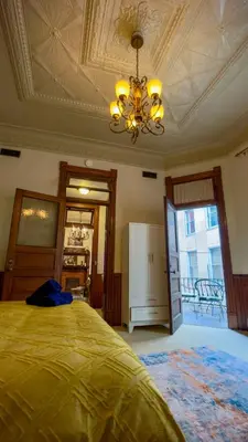 a bedroom with a gold bed and a ceiling at Court St Suite in Clarksburg