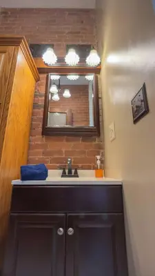 a bathroom with a sink and a mirror at Court St Suite in Clarksburg
