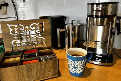 a coffee maker and a cup of coffee on a table at Fiesinger House - Entire Historic Home, Downtown Sandusky in Sandusky