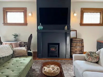 a living room with a couch and a fireplace at Fiesinger House - Entire Historic Home, Downtown Sandusky in Sandusky