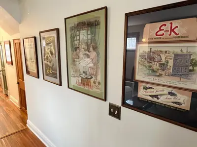 a group of framed posters on a wall at Fiesinger House - Entire Historic Home, Downtown Sandusky in Sandusky