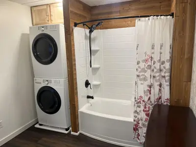 a bathroom with a washing machine and a bath tub at Apartment in Newark in Newark