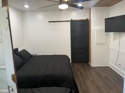 a bedroom with a bed and a black door at Apartment in Newark in Newark