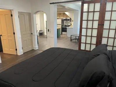 a bedroom with a large bed and a kitchen at Apartment in Newark in Newark