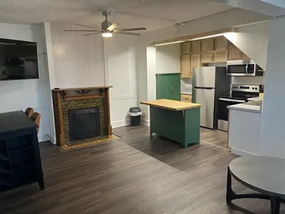 a kitchen with a fireplace in the middle of a room at Apartment in Newark in Newark