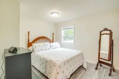 a bedroom with a bed and a mirror and a dresser at Grand Lake Getaway with Boat Dock in St Marys!