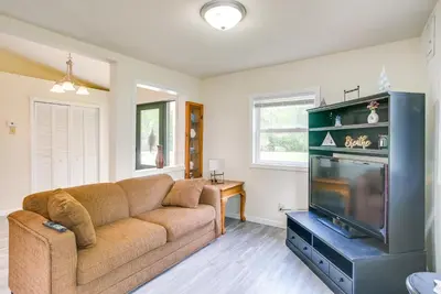 a living room with a couch and a flat screen tv at Grand Lake Getaway with Boat Dock in St Marys!