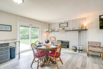 a dining room with a table and chairs and a fireplace at Boat Dock Couples Grand Lake Getaway!