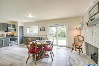 a kitchen with a table and chairs and a fireplace at Boat Dock Couples Grand Lake Getaway!