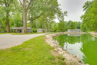 a road next to a lake with houses in the background at Boat Dock Couples Grand Lake Getaway!