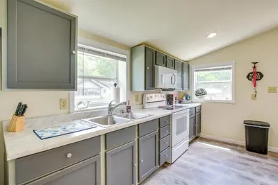 a kitchen with gray cabinets and a sink at Grand Lake Cabin with Private Dock in St Marys!
