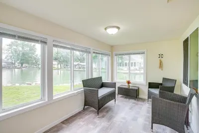 a room with windows with chairs and a table at Grand Lake Cabin with Private Dock in St Marys!