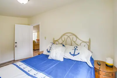 a bedroom with a bed with blue and white pillows at Grand Lake Cabin with Private Dock in St Marys!
