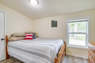 a bedroom with a bed and a window at Grand Lake Cabin with Private Dock in St Marys!