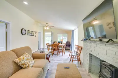 a living room with a couch and a fireplace at Grand Lake Cabin with Private Dock in St Marys!
